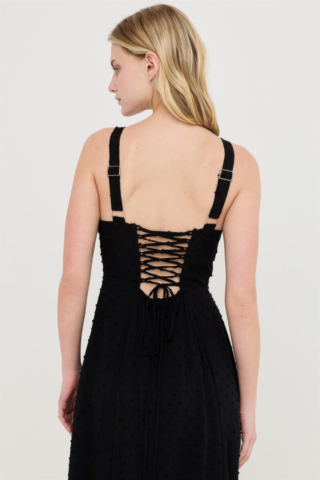 Black dress back with crisscross lacing detail and adjustable tie straps.