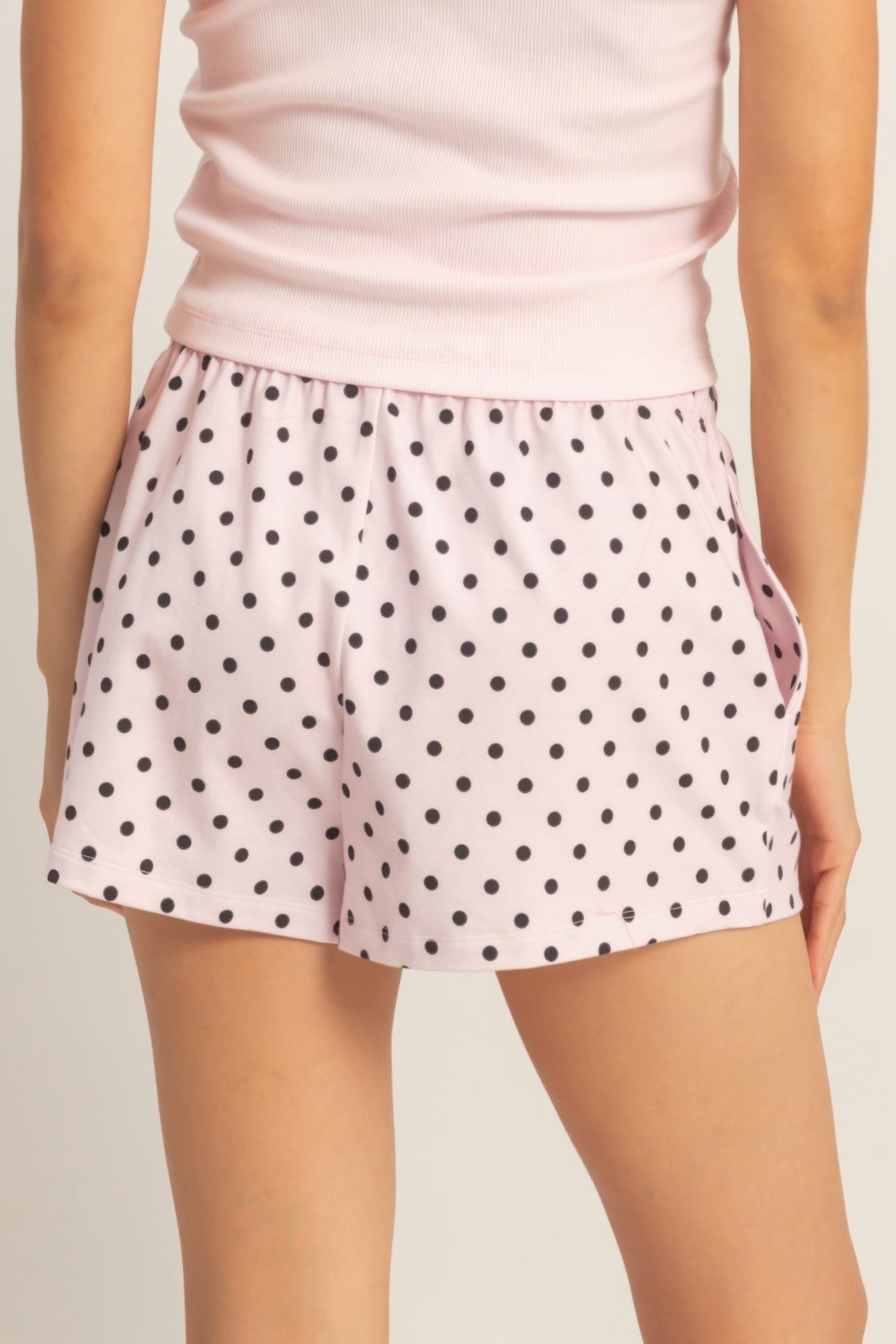 Polka dot drawstring shorts with black dots, elastic waistband and relaxed fit.
