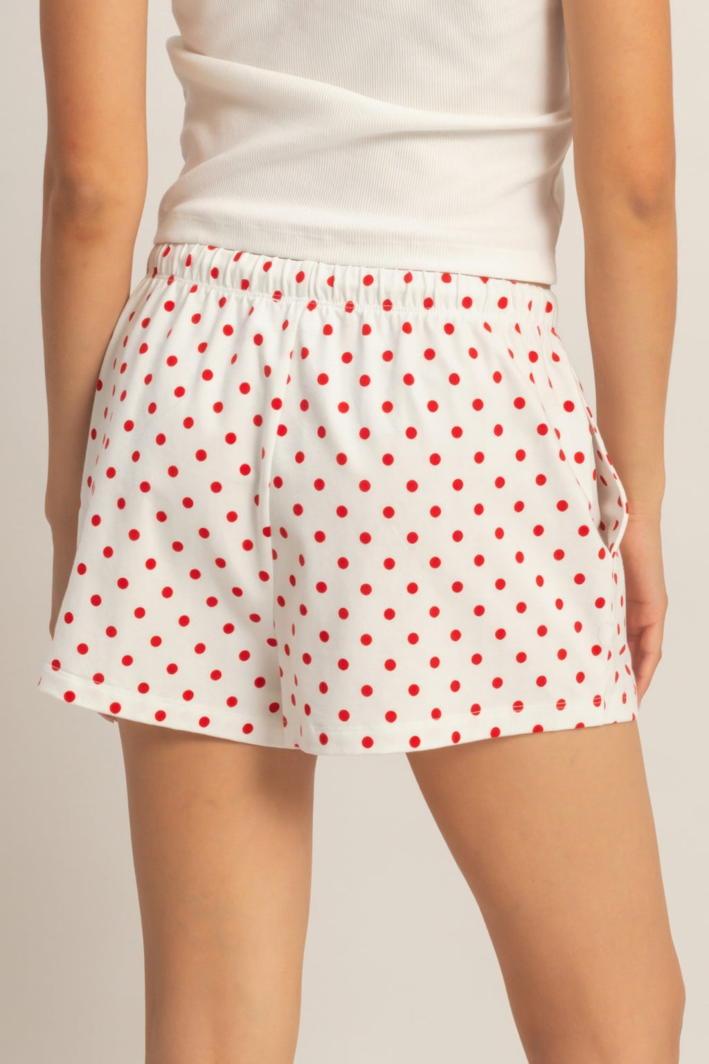 White shorts with red polka dots, elastic waist and side drawstring detail