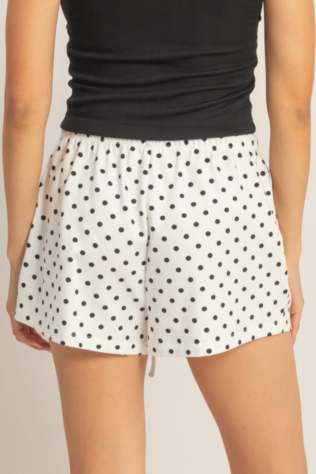 White polka dot drawstring shorts with black dots, elastic waist