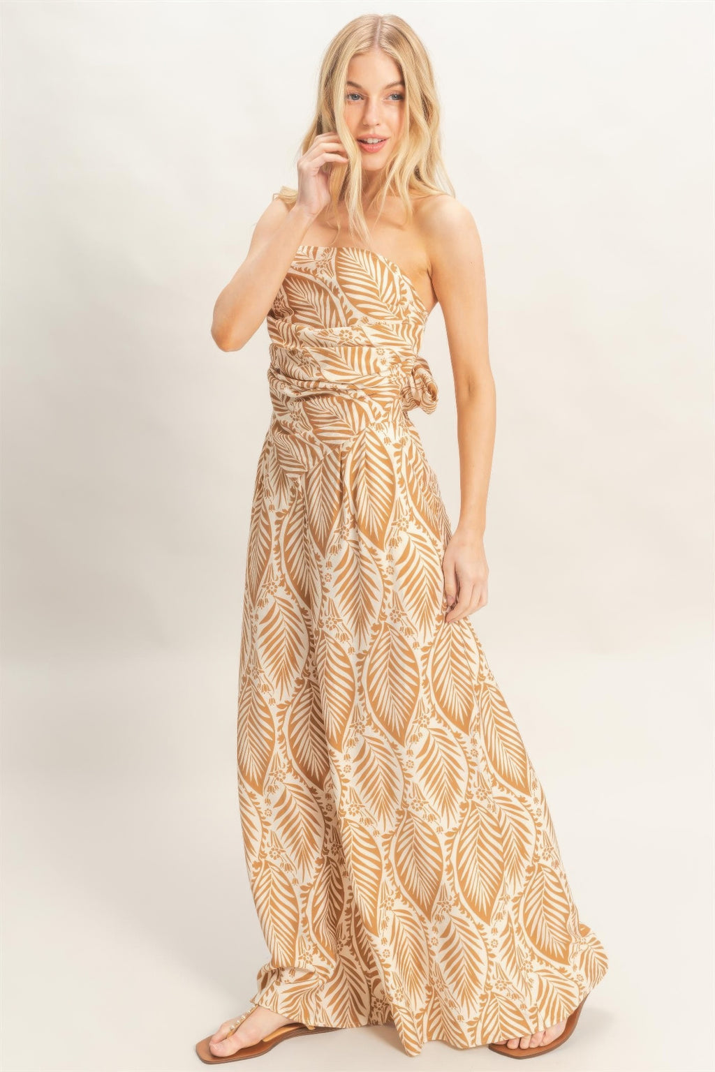 Light brown strapless print set with tied waist detail and flowing wide-leg pants