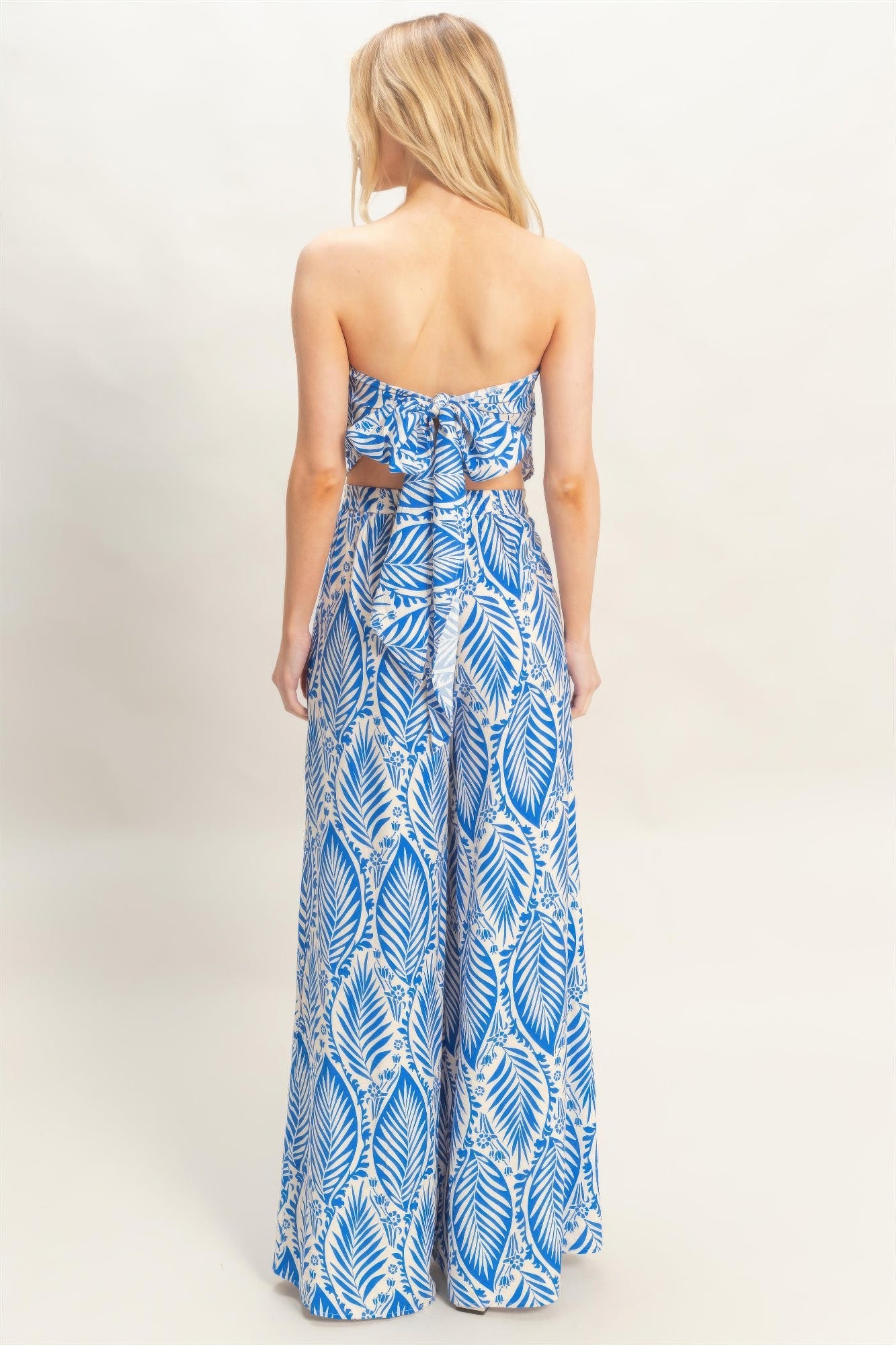 Blue leaf-print strapless set from back view, smocked waist with wide-leg pants