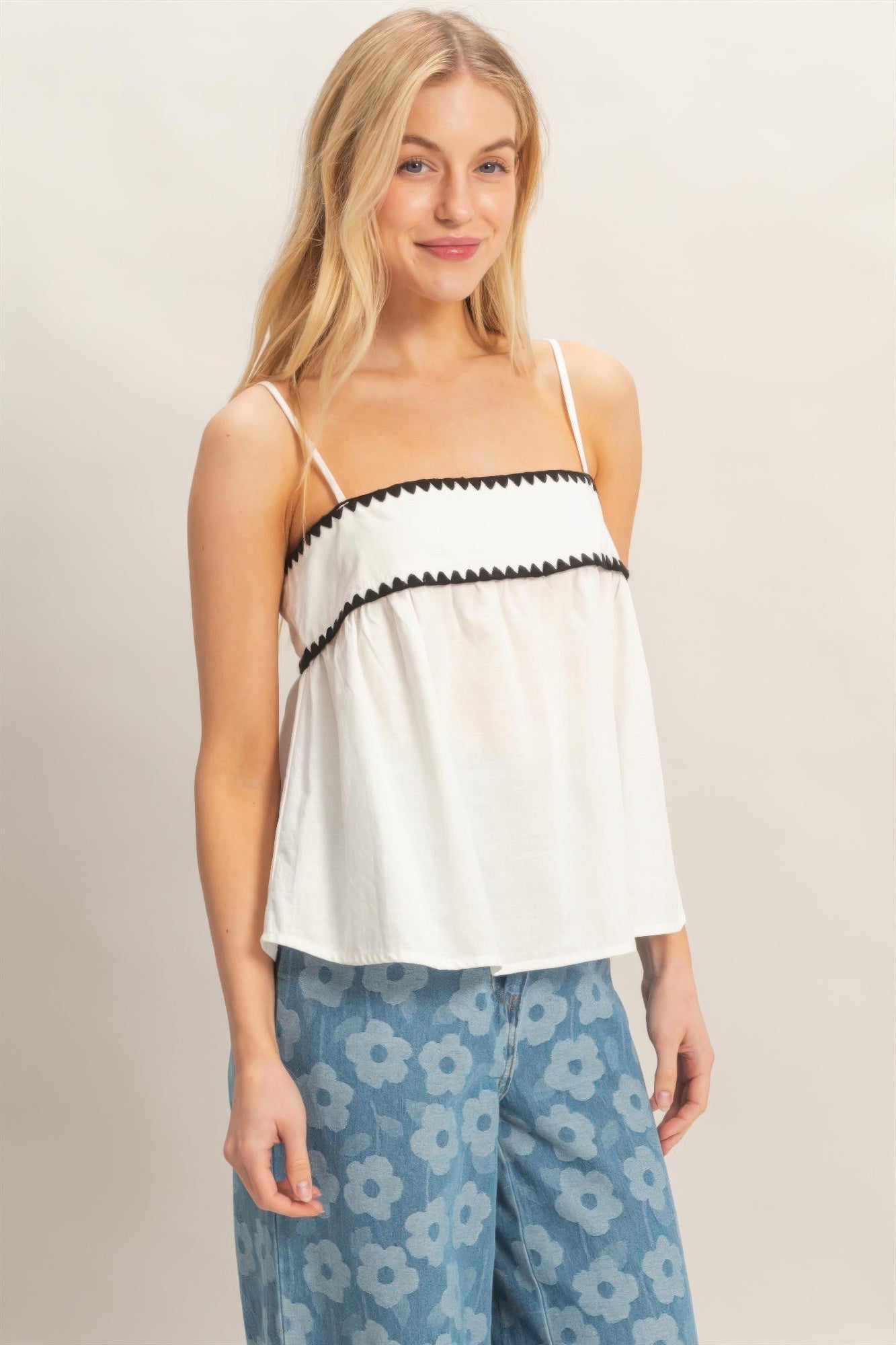 White babydoll top with black scalloped neckline band and thin spaghetti straps