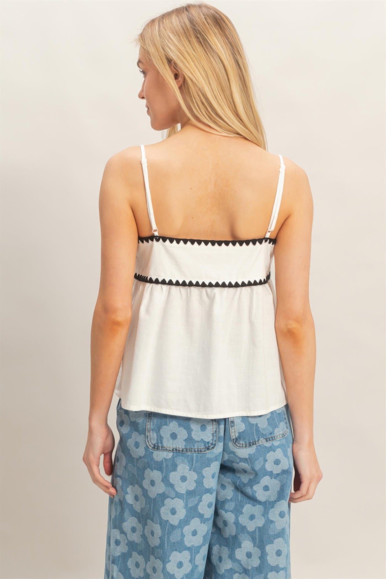 Back view sleeveless babydoll top, white with black zigzag trim and thin straps