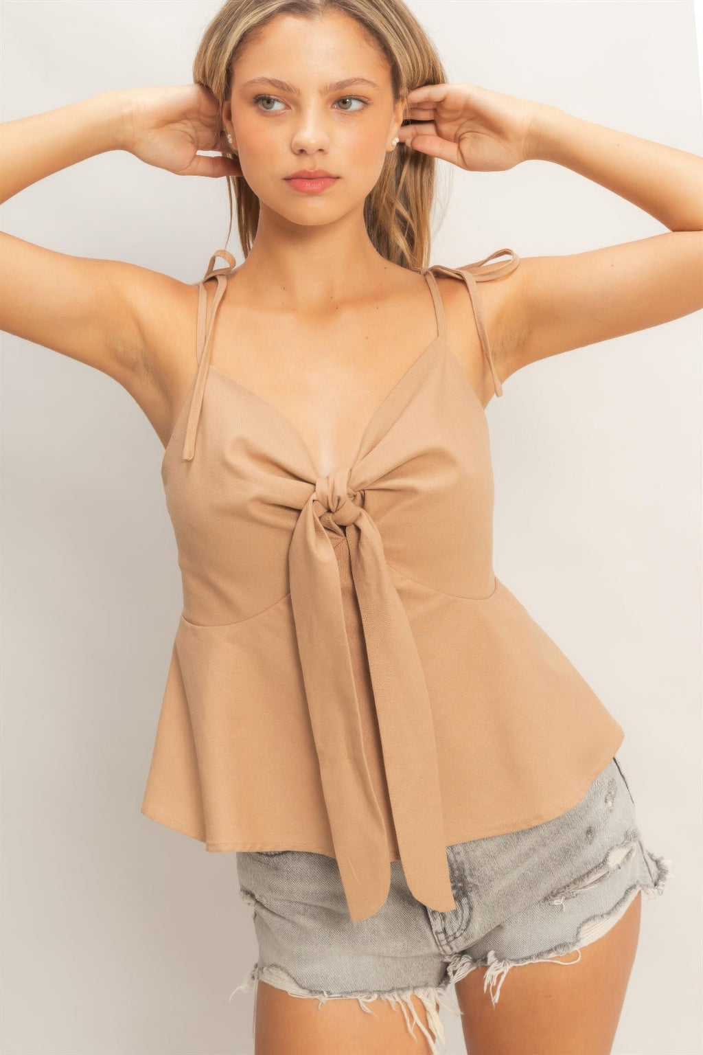 Dark taupe tie-front spaghetti strap peplum top with center bow detail