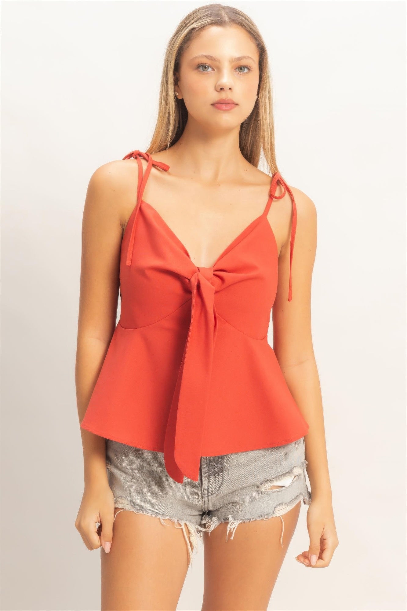 Tomato red tie-front spaghetti strap peplum top with front bow at neckline