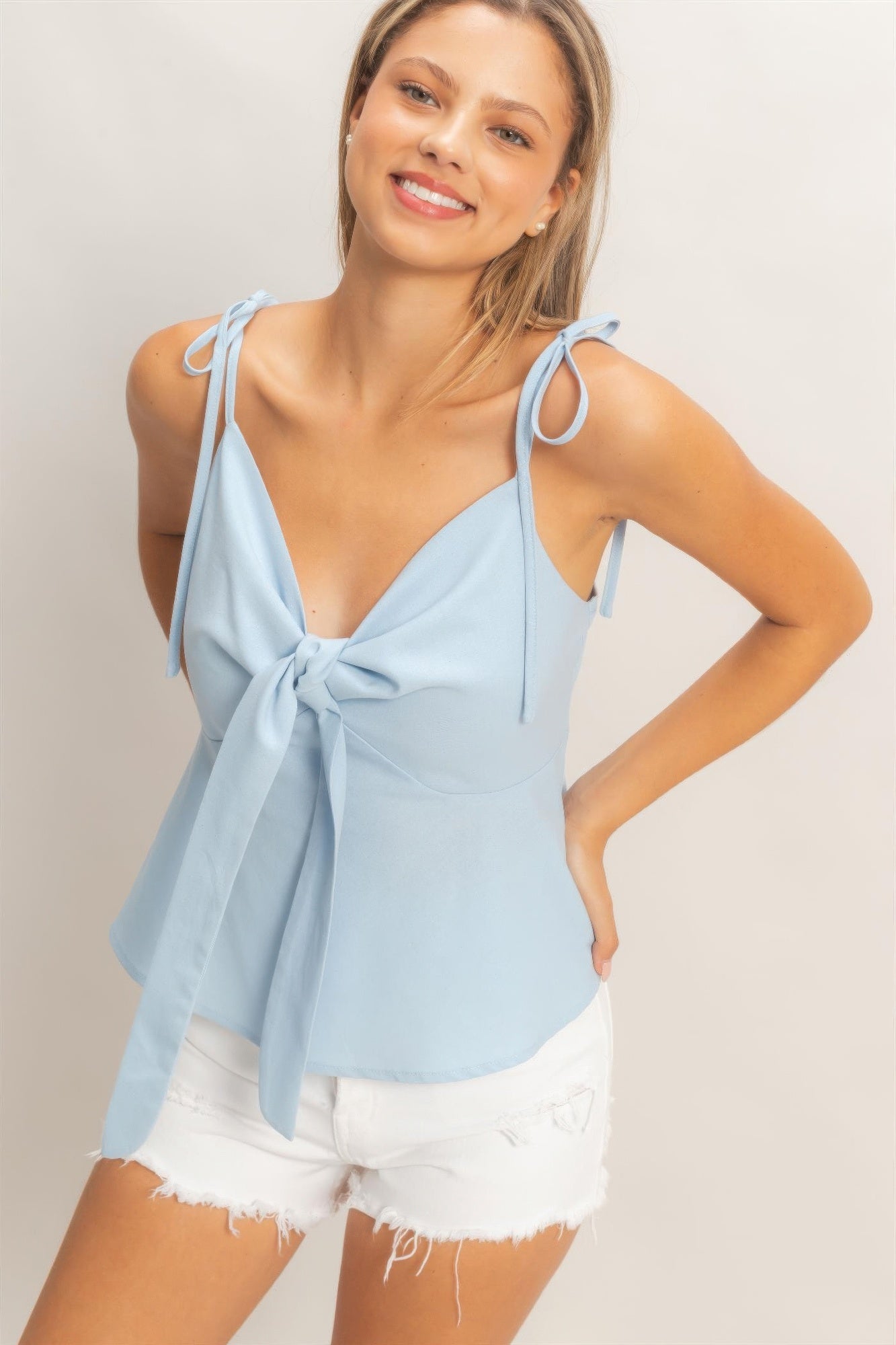 Light blue bow-tied V-neck spaghetti strap top with flowing tie-front
