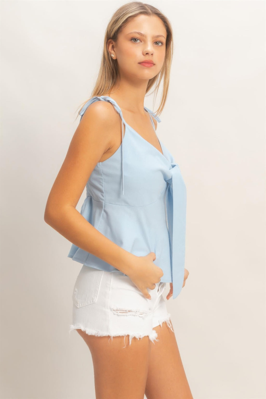 Light blue tie-front spaghetti strap top with bow detail at bust