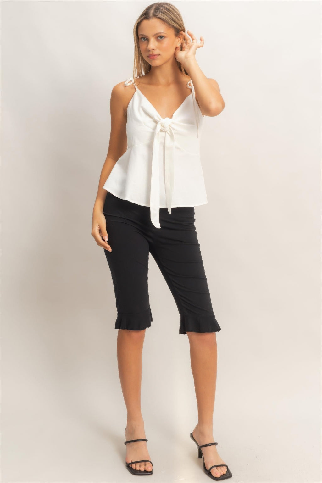 Tie-front spaghetti strap peplum top in ivory white with long bow ties