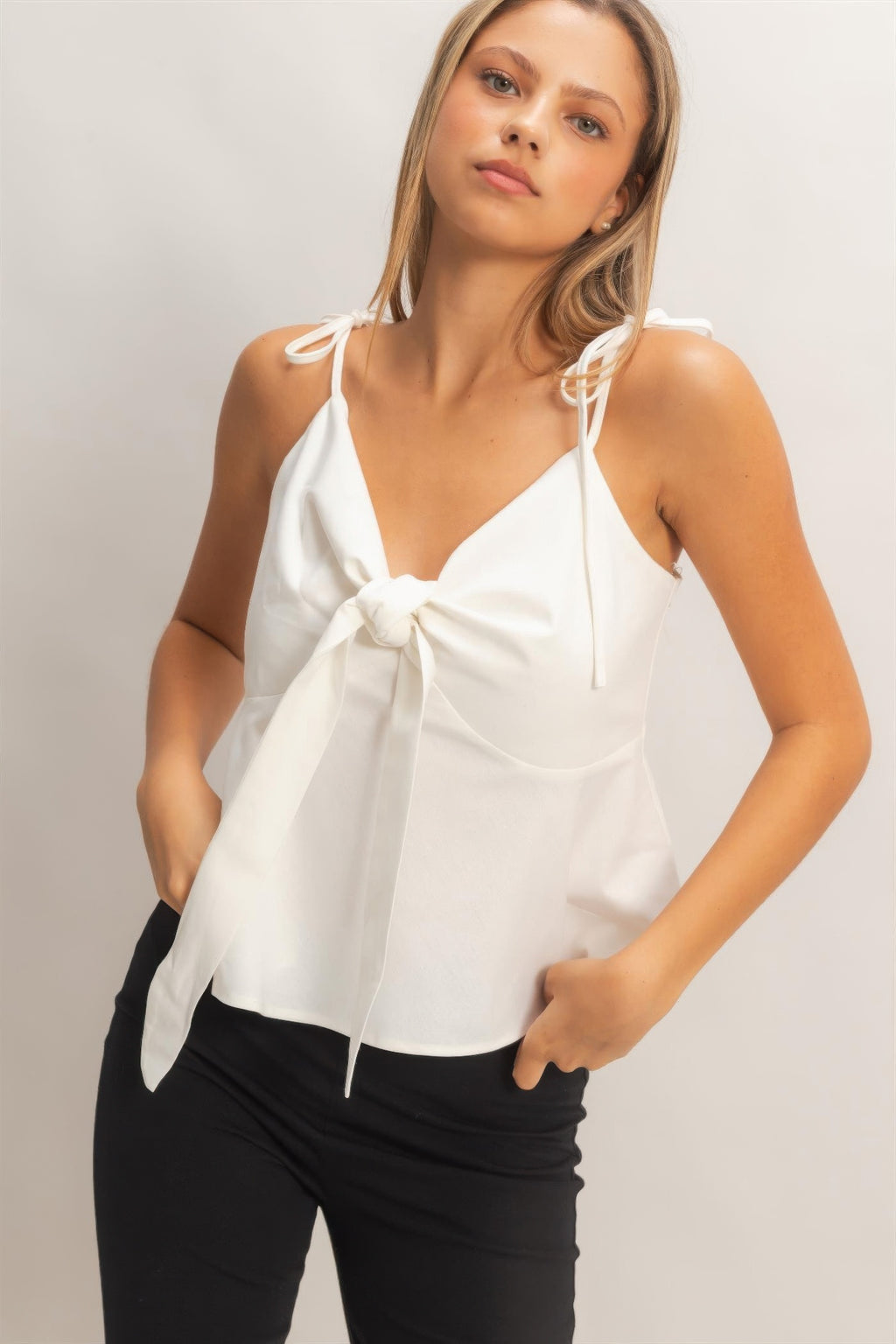 Ivory tie-front camisole top with spaghetti straps and bow-tied neckline