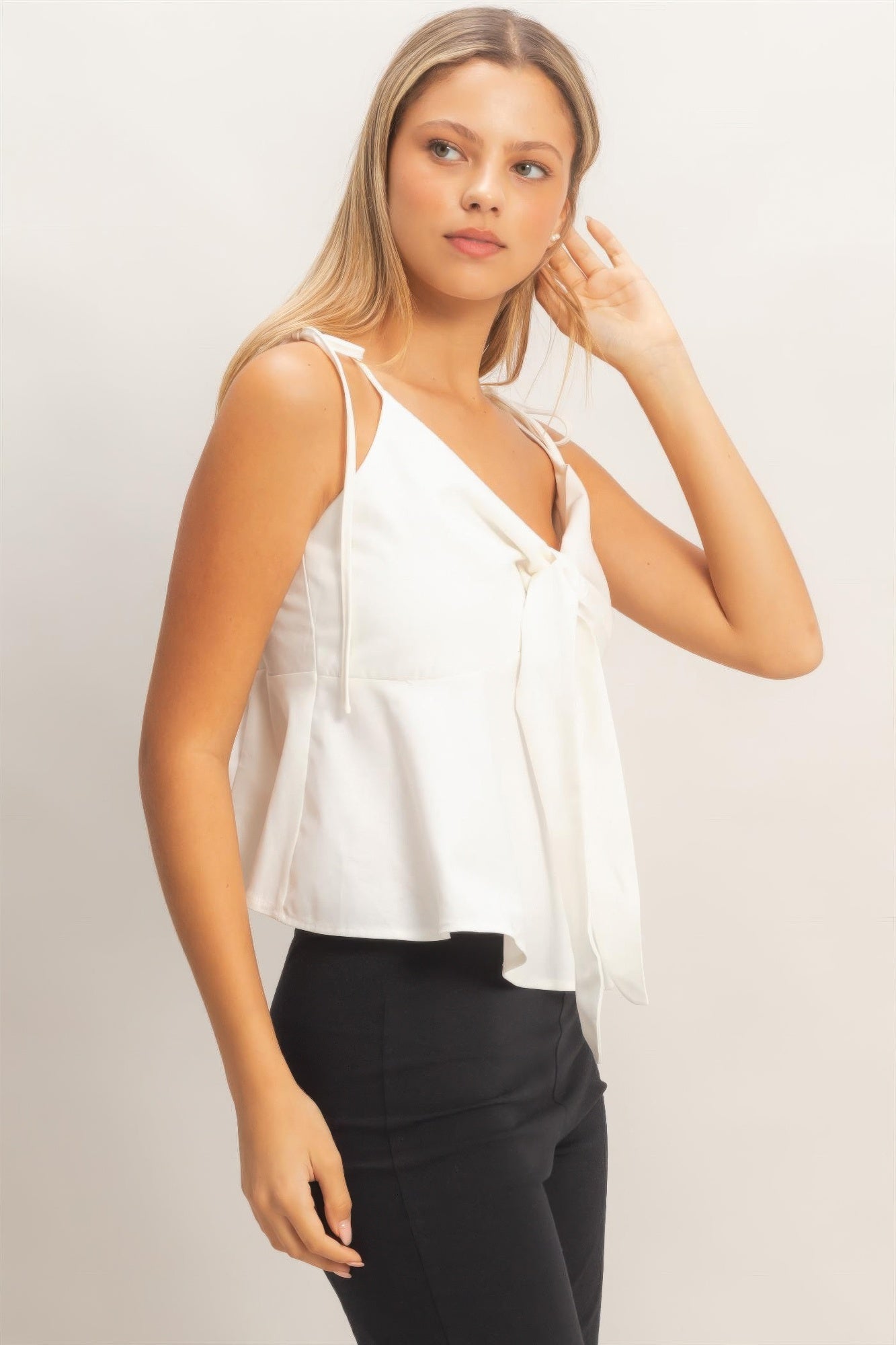 Ivory tie-front spaghetti strap top with V-neck and long shoulder ties