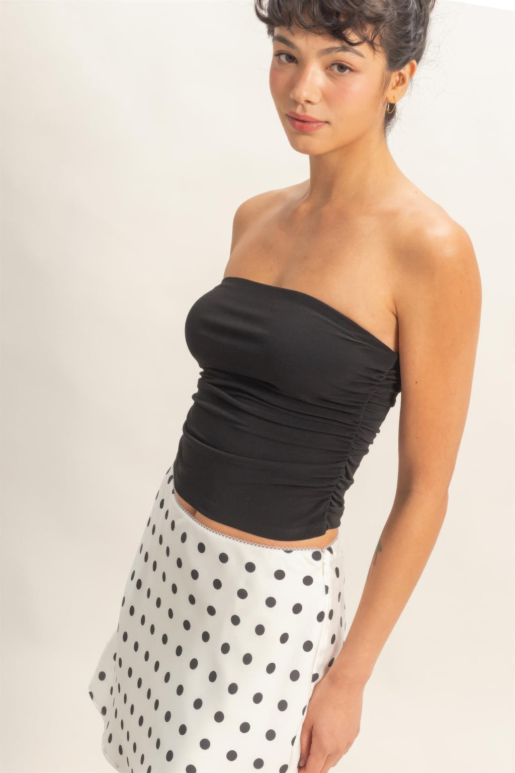 Black ruched bandeau top with gathered fabric at side seam
