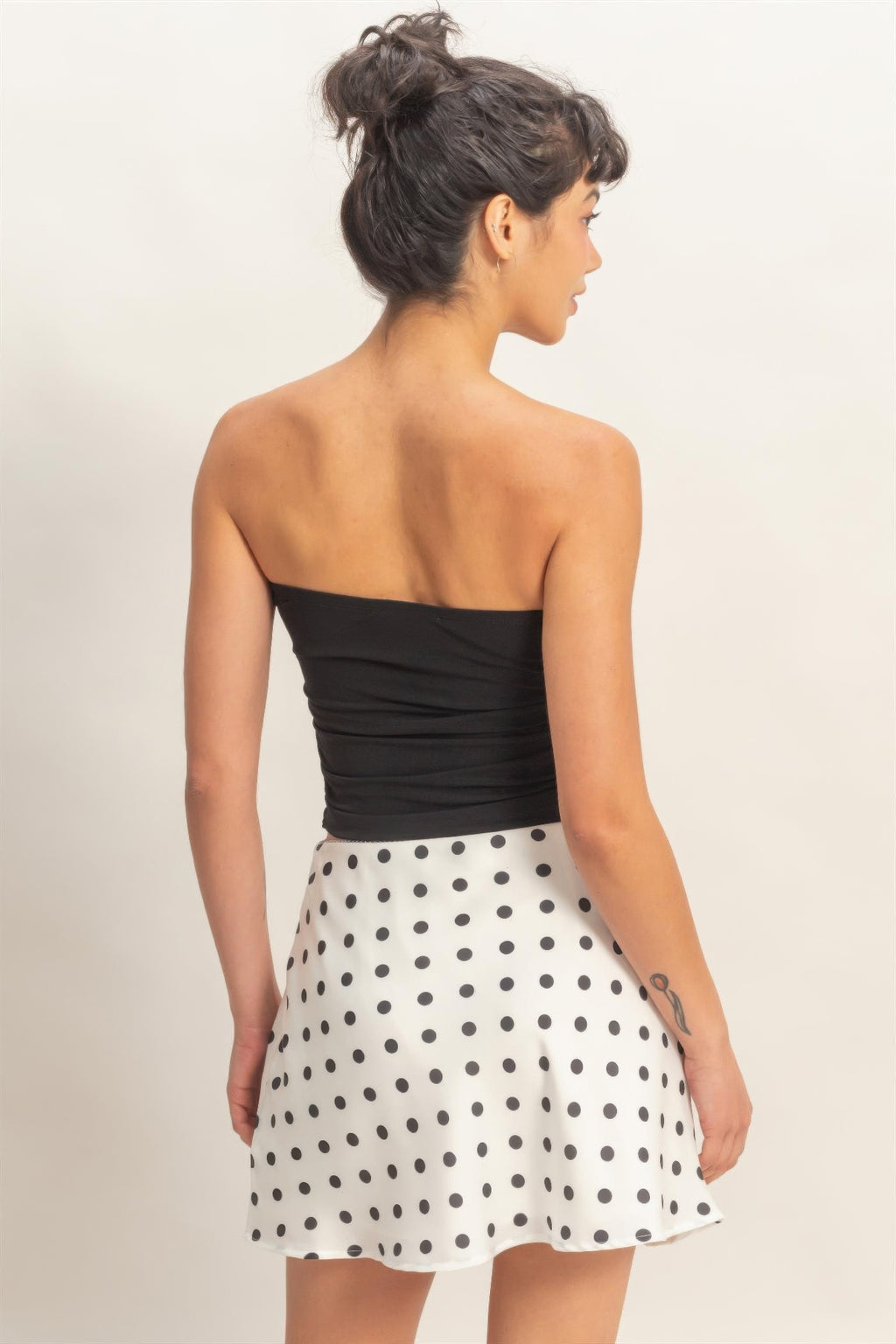 Black ruched bandeau top from back view with gathered fit and strapless cut