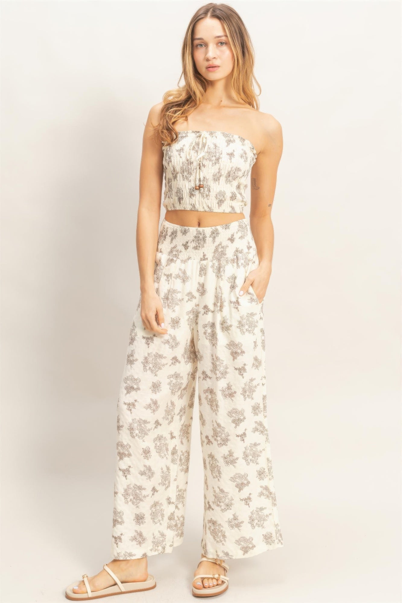 Smocked tube top & wide-leg pants set, light base with gray floral print.