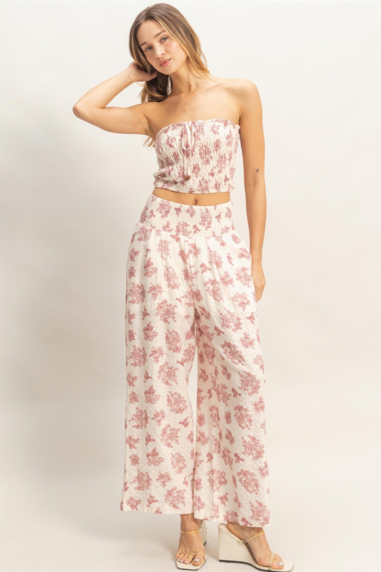 Smocked tube top & wide-leg pants set, light base with red floral print, front view.