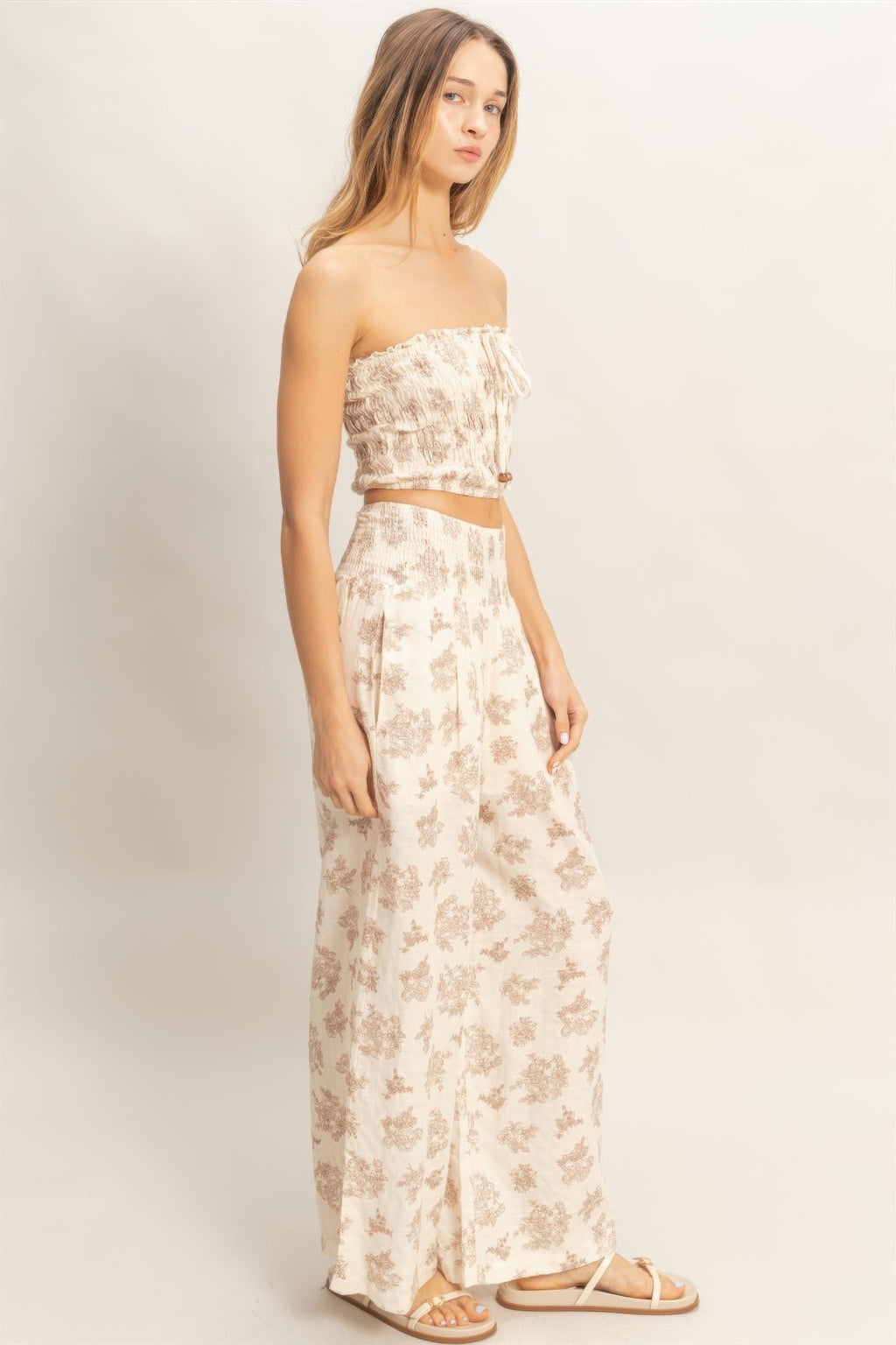 Strapless smocked tube top and flowing wide-leg floral pants, beige set