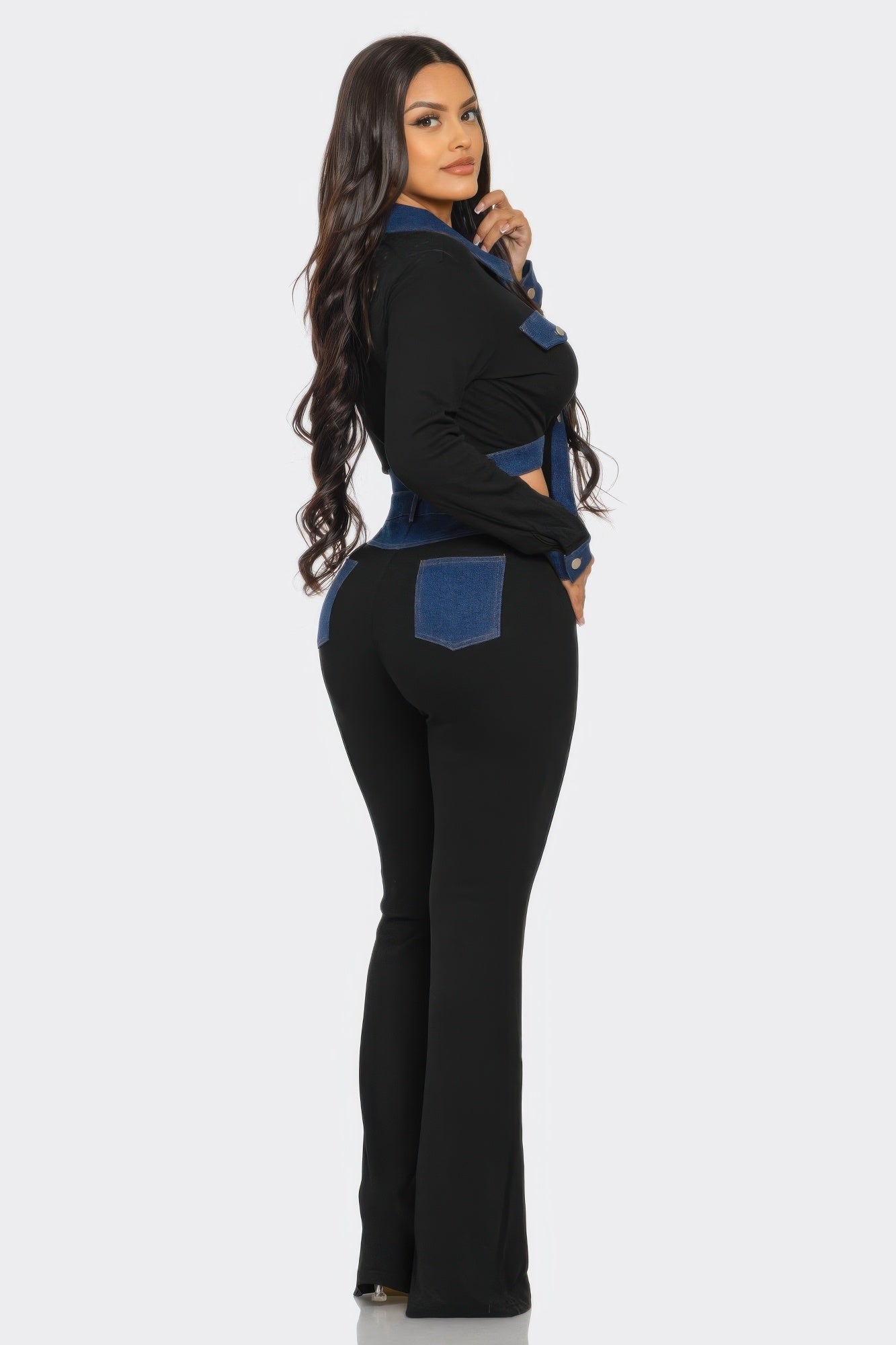 Side view of denim contrast set: black flared pants with blue panel jacket