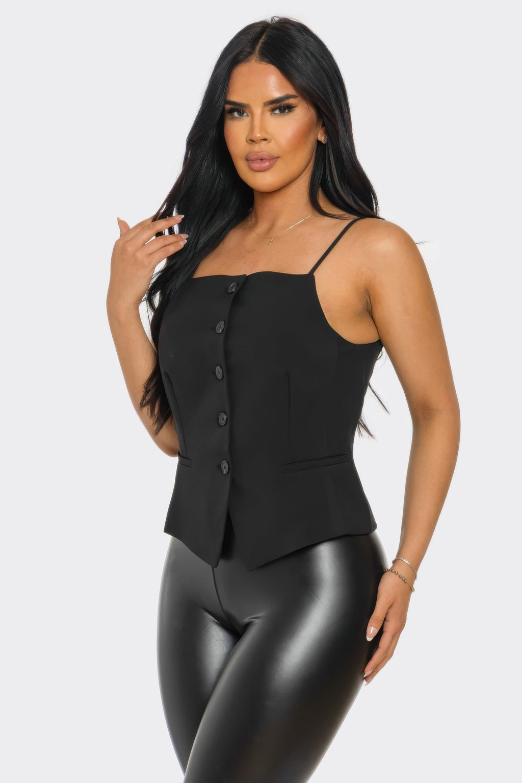 Black corset vest-style top with thin straps, button placket, and waist seam