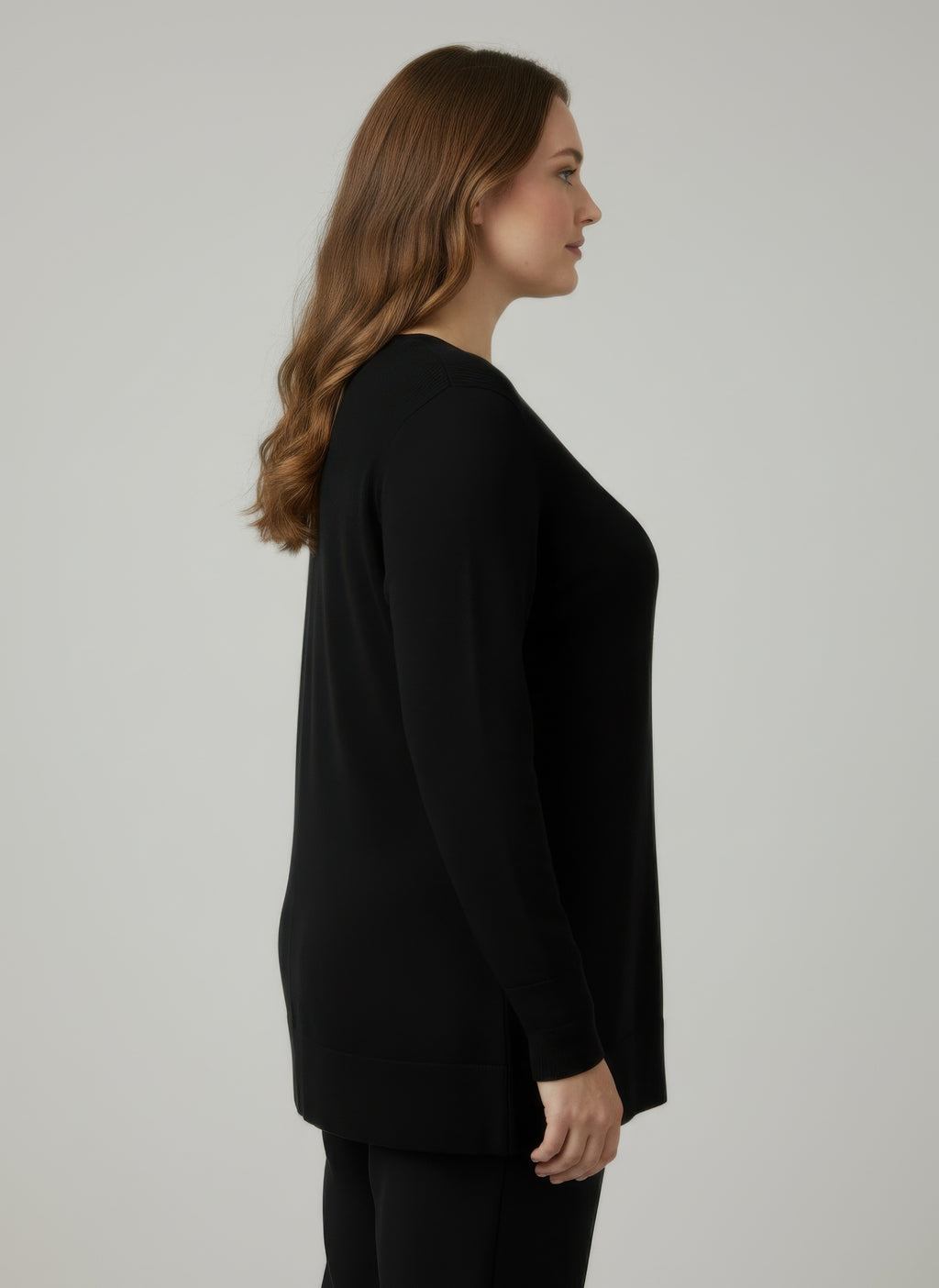 Ribbed knit tunic top, black; side view highlighting 3/4 sleeves and cuff buttons