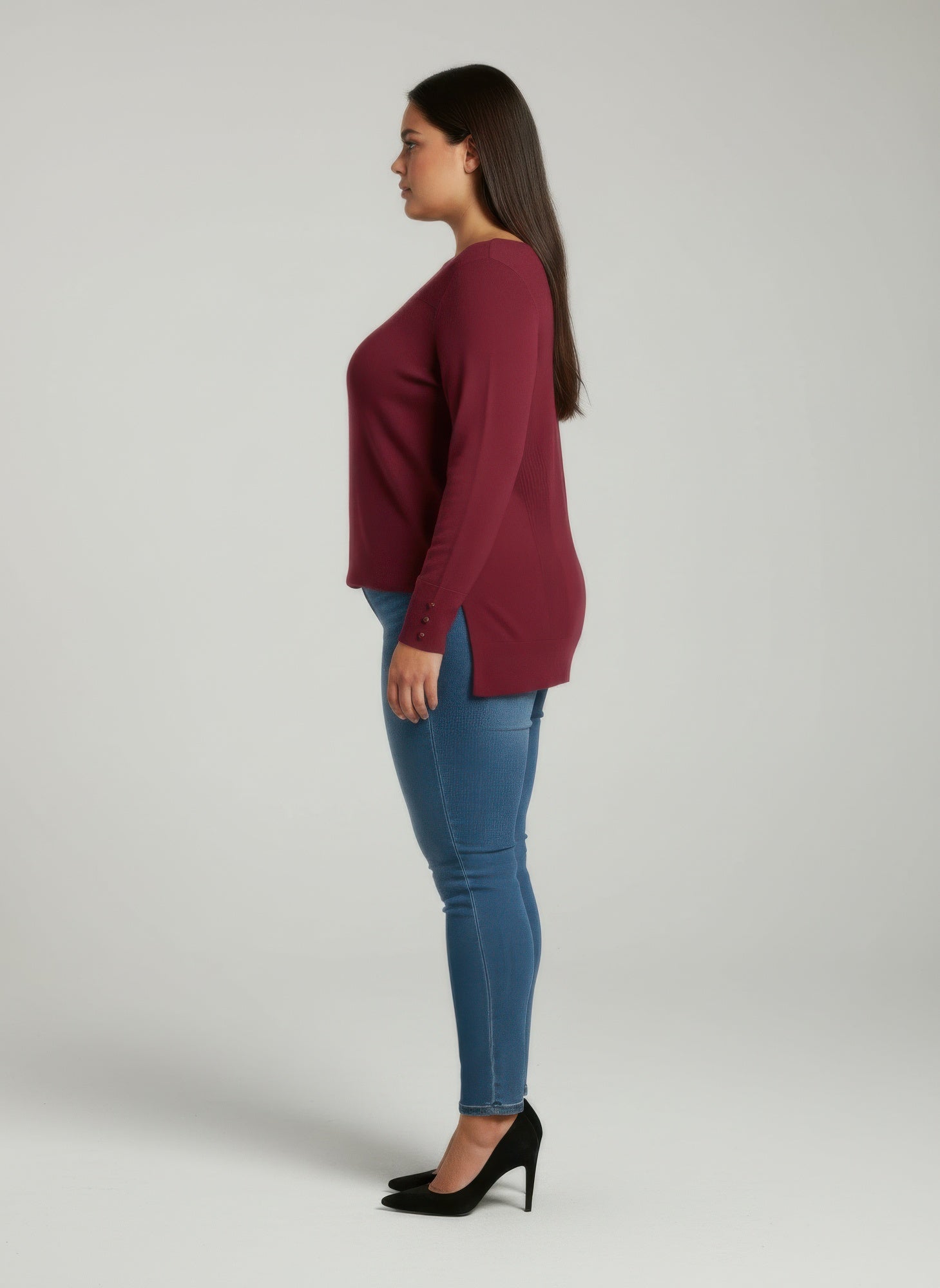 Side view: wine ribbed knit tunic top with button cuffs