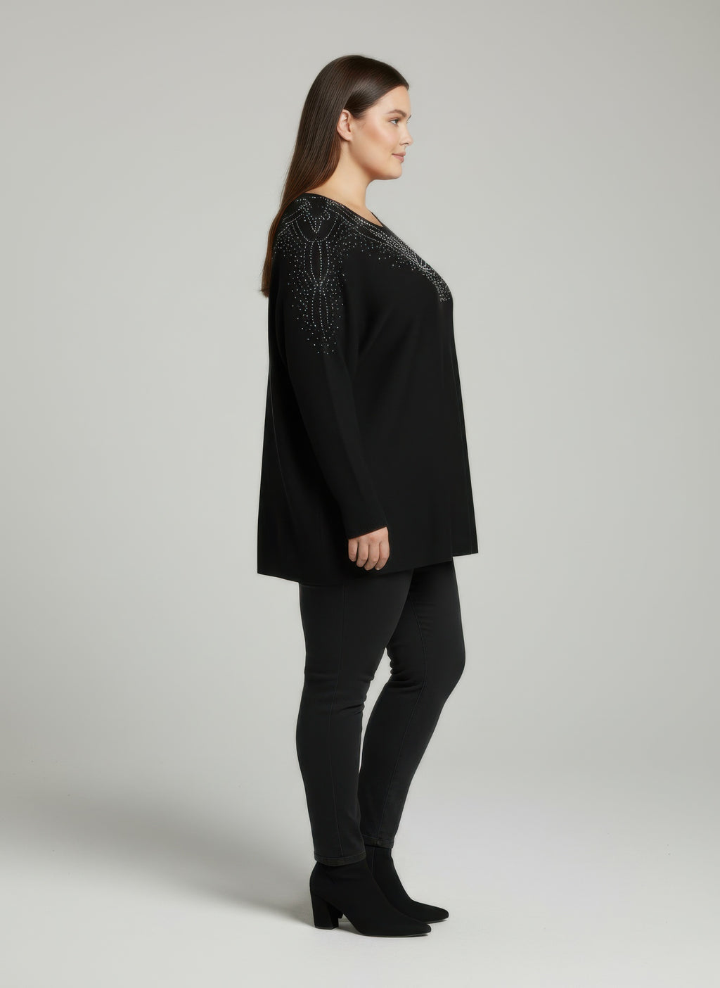 Black dolman sleeve tunic top, side view, embellished neckline