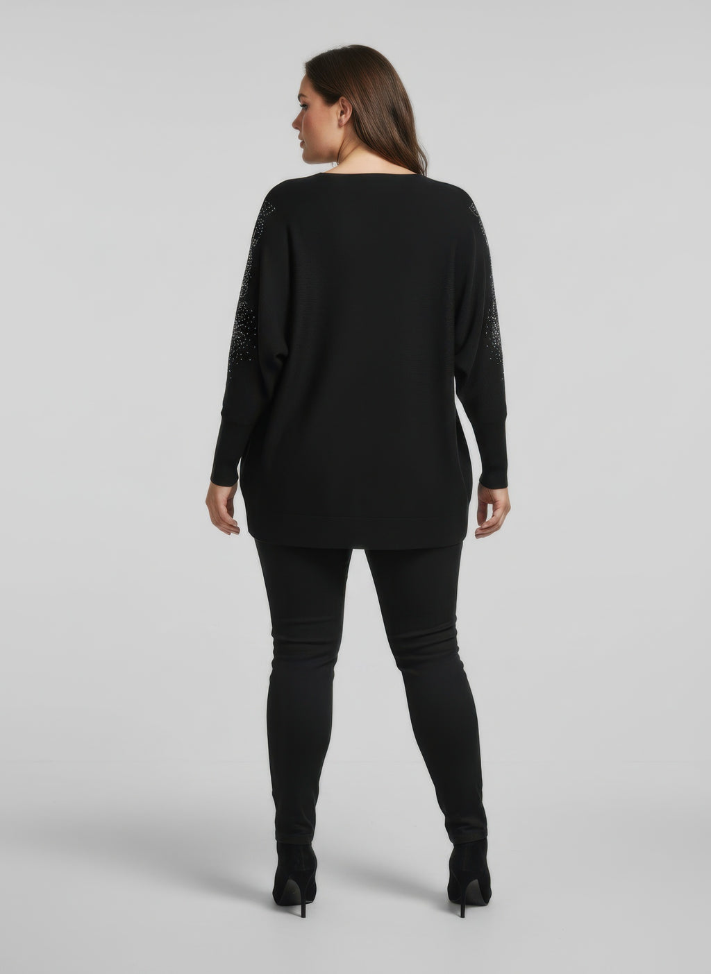 Black embellished knit tunic top with sparkly detail at sleeves, back view