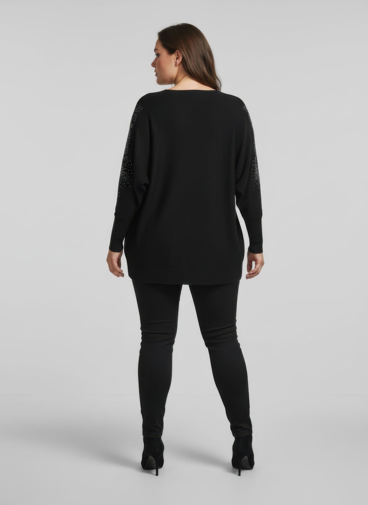 Black embellished knit tunic top with sparkly detail at sleeves, back view