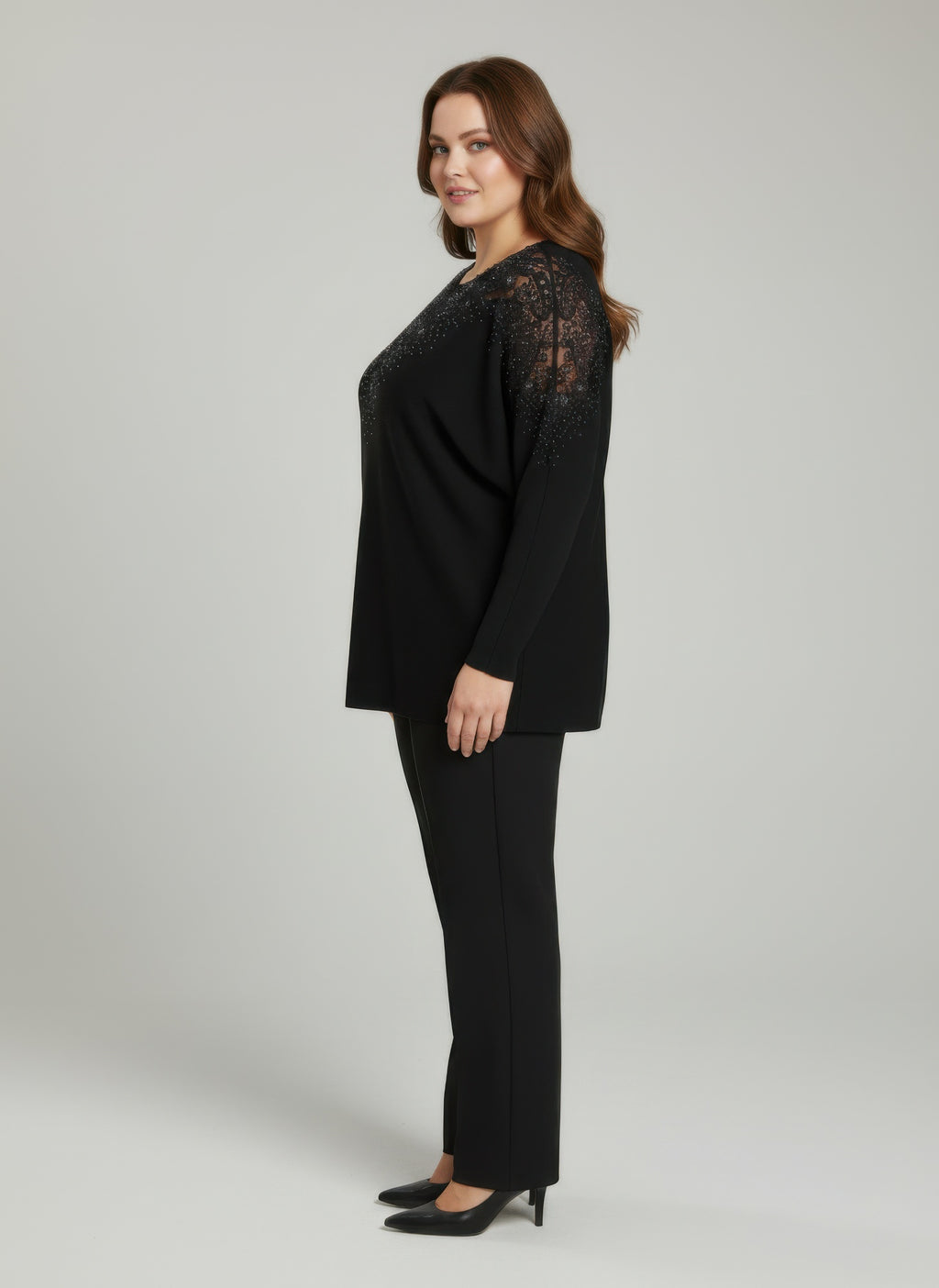 Black knit tunic top with sheer lace sleeves and embellished neckline