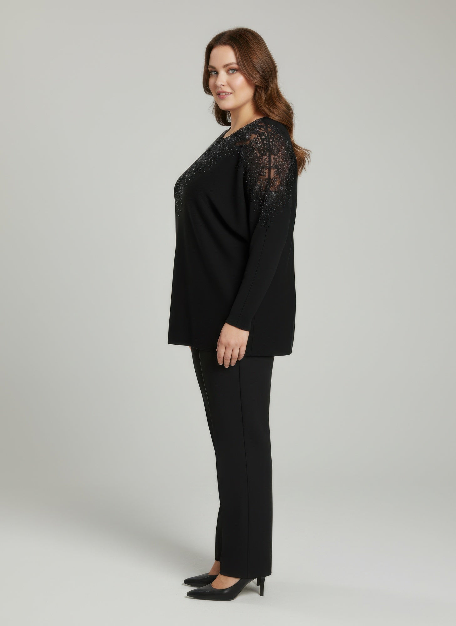 Black knit tunic top with sheer lace sleeves and embellished neckline