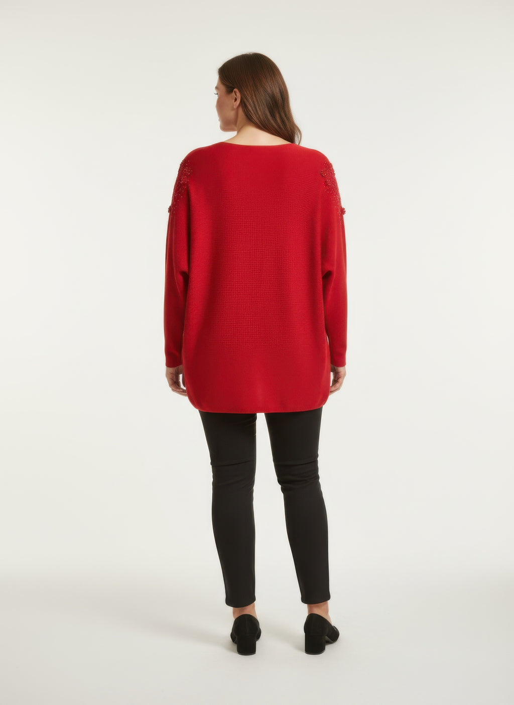 Red knit tunic top with lace-like shoulder embellishment, relaxed back view