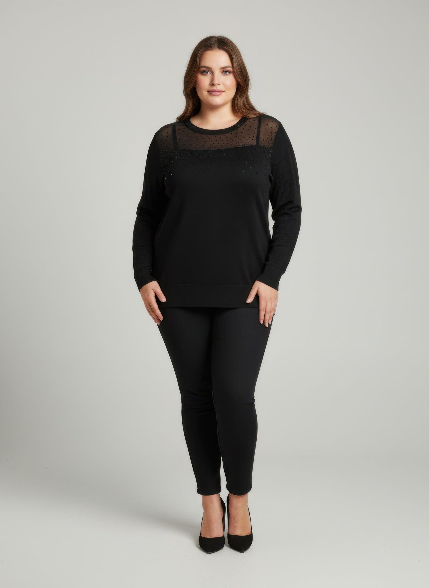 Black knit tunic top with sheer mesh yoke, long sleeves, crew neck