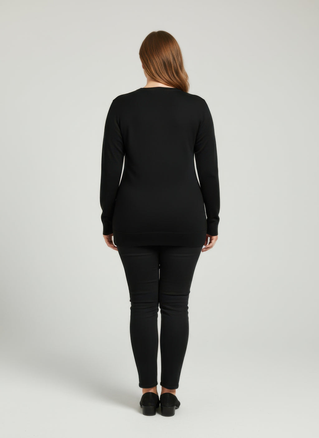 Black knit tunic top, back view, long sleeves and crew neckline