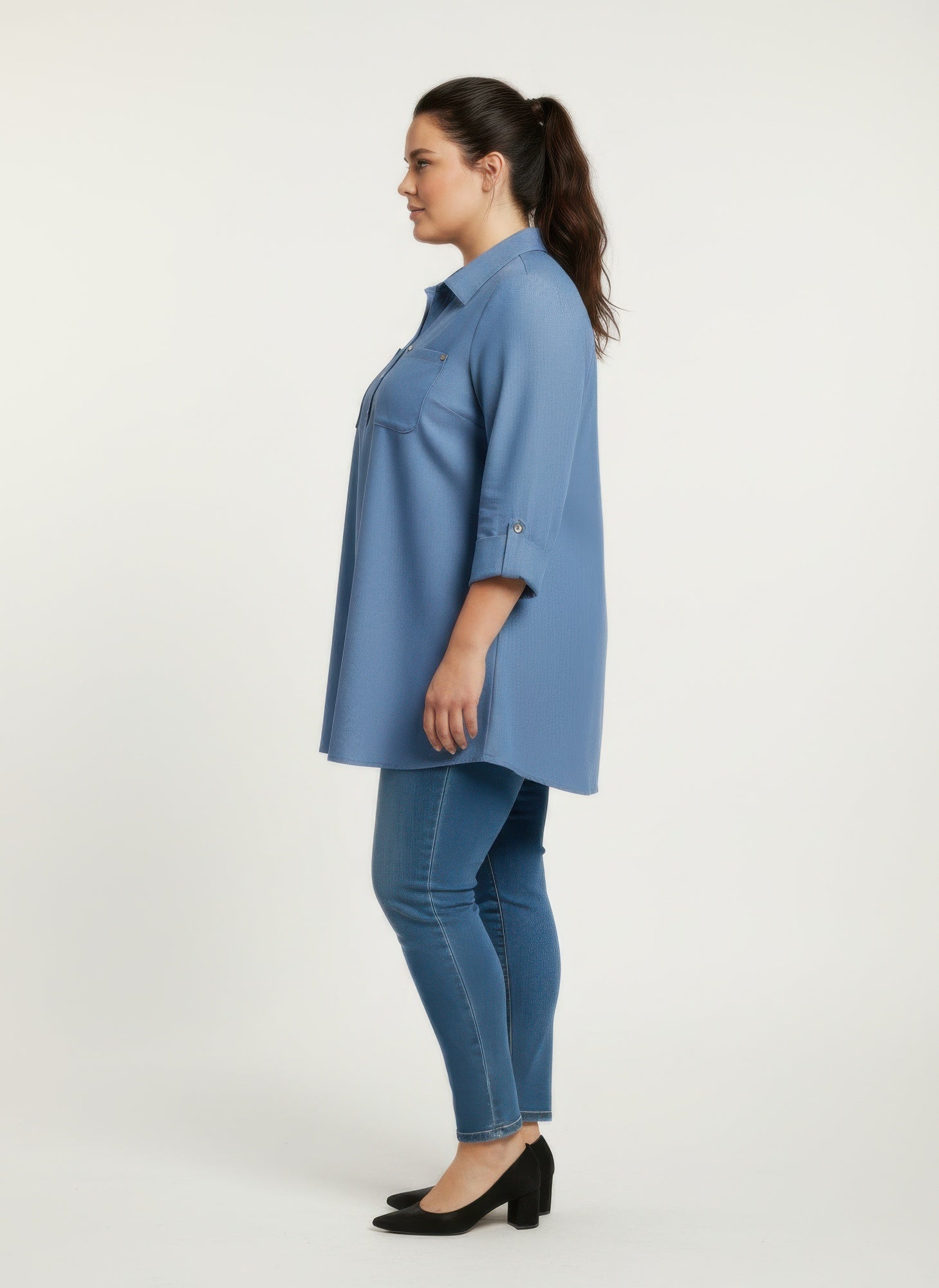 Blue button-front blouse with roll sleeves, side view