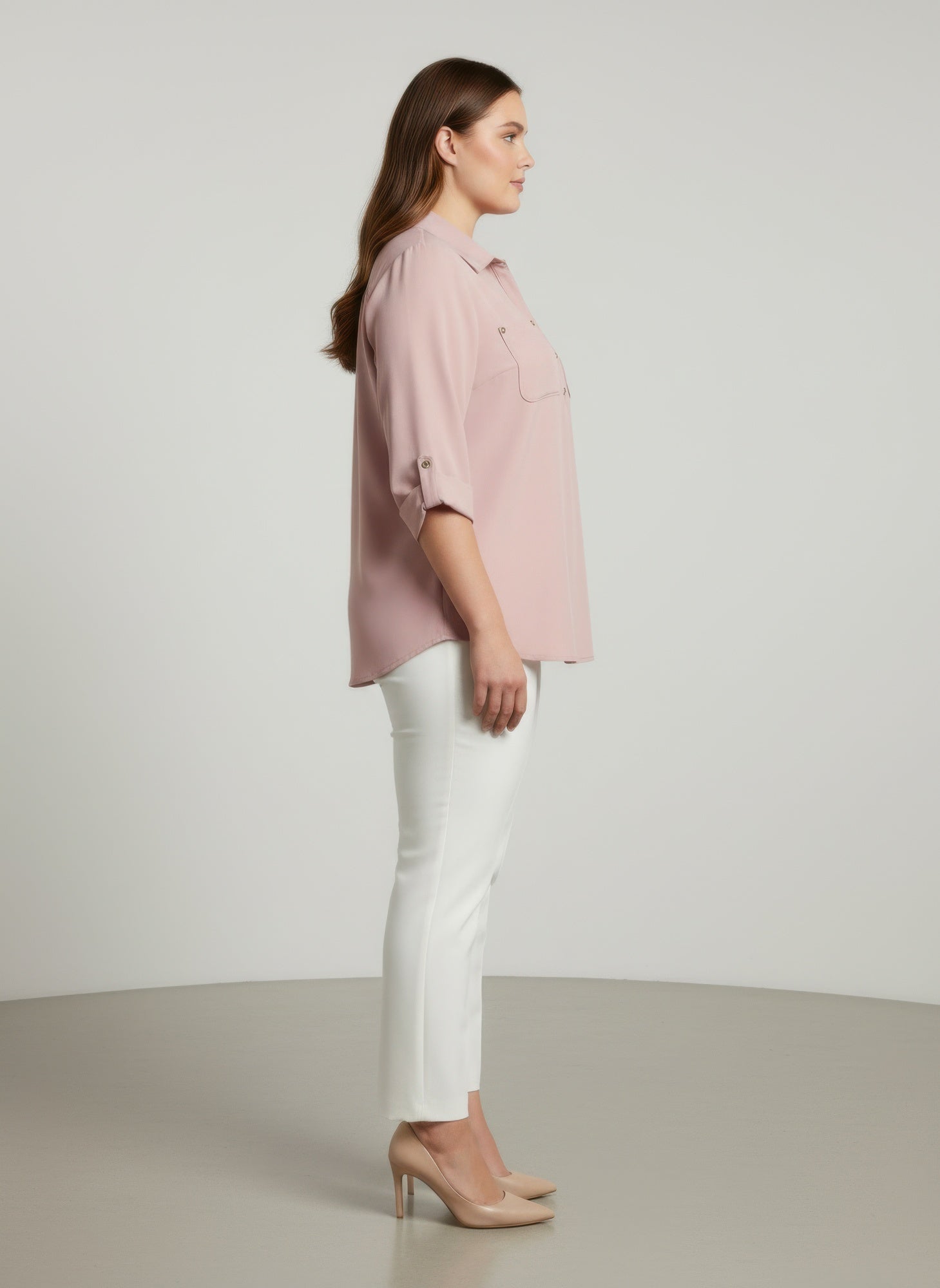 Blush pink button-front blouse with roll sleeves, side view