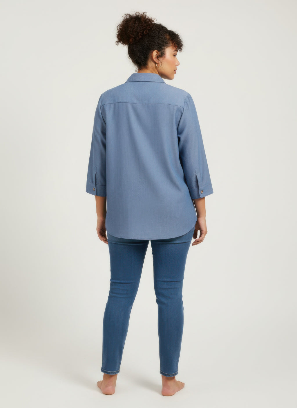 Blue utility button-front tunic shirt back view with 3/4 sleeves and yoke seams