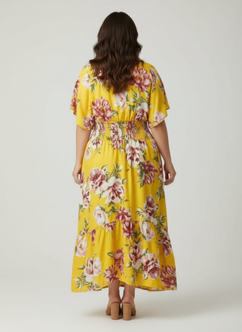 Back view: yellow floral tiered plus-size dress with gathered waist and V-neck