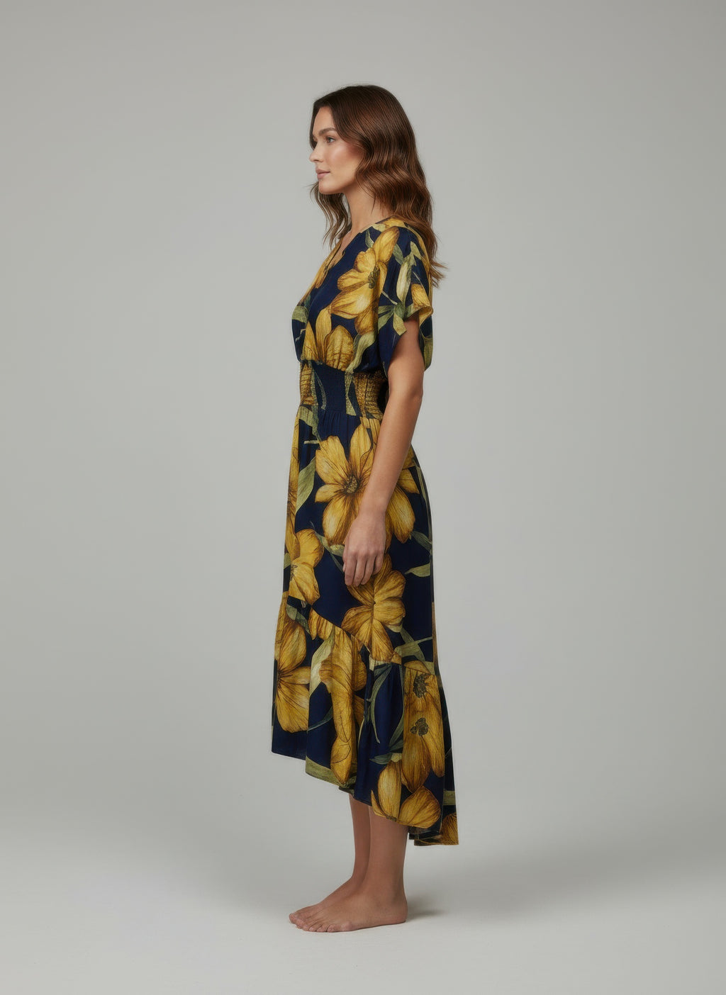 Navy floral dress with large yellow leaves, short flutter sleeves, side view