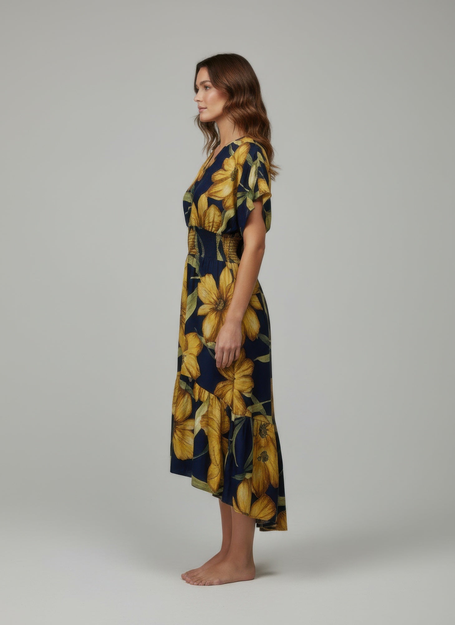Navy floral dress with large yellow leaves, short flutter sleeves, side view