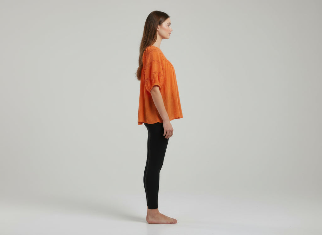 Unique Spectrum solid short sleeve blouse, orange side view with loose dolman sleeves