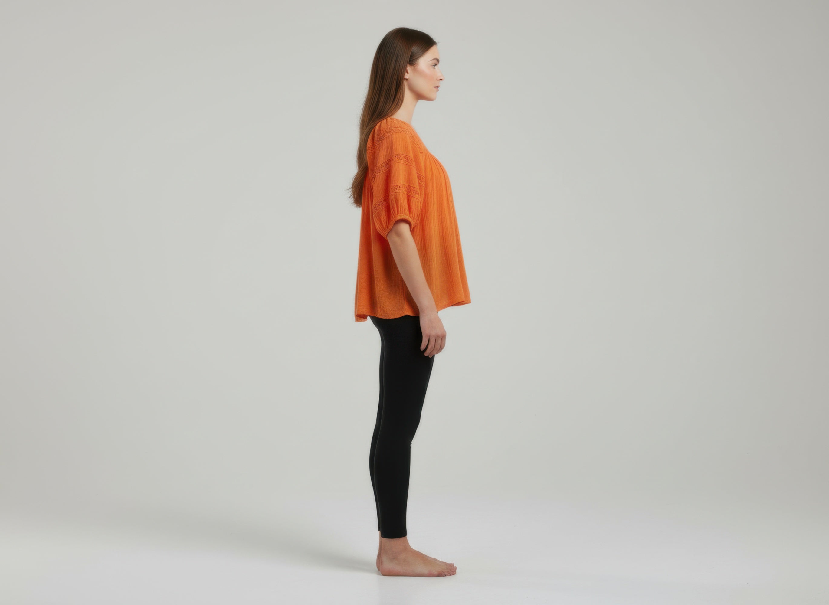 Unique Spectrum solid short sleeve blouse, orange side view with loose dolman sleeves