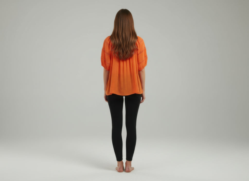 Unique Spectrum solid short sleeve blouse, orange back view with gathered yoke detail
