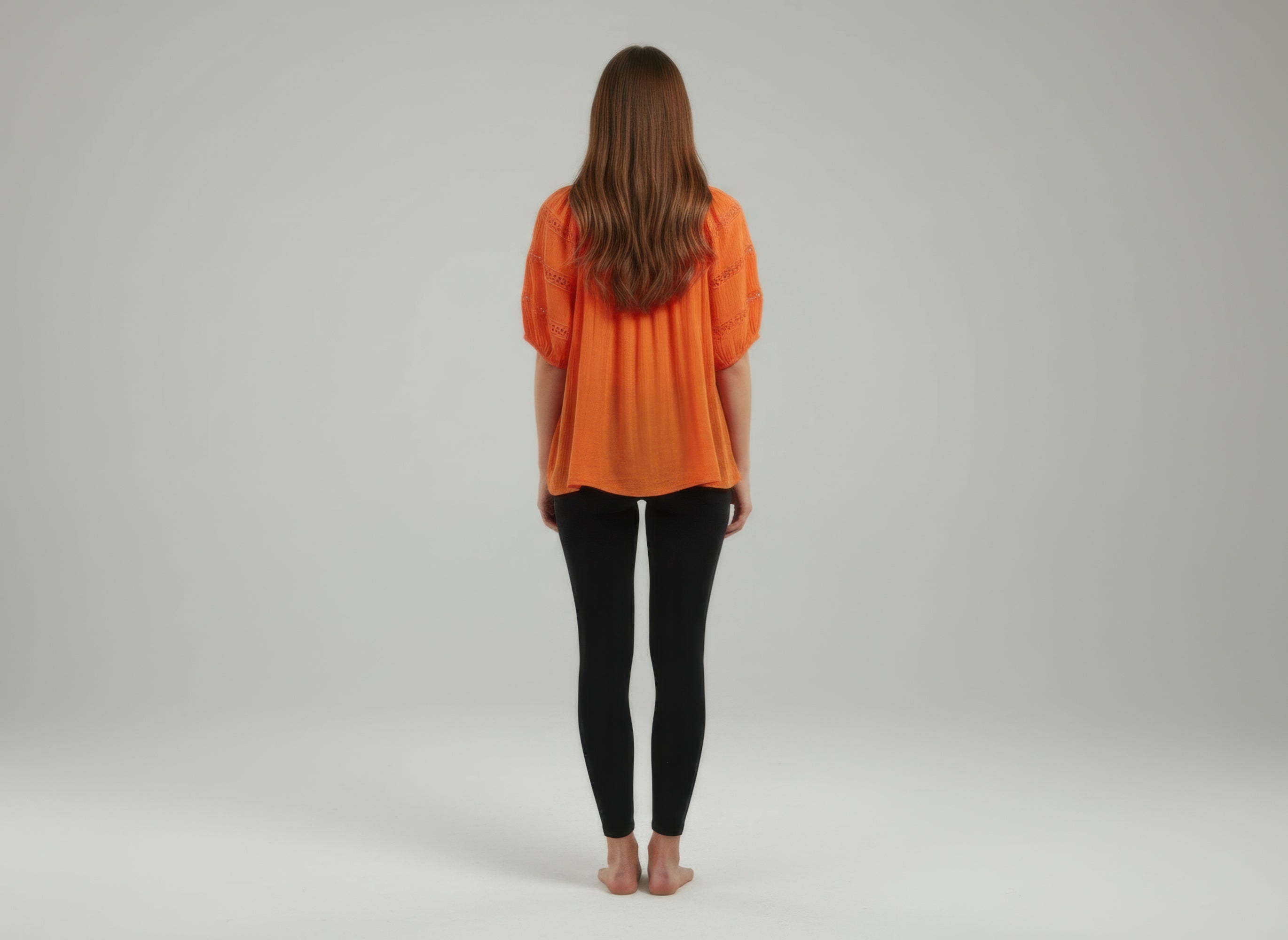 Unique Spectrum solid short sleeve blouse, orange back view with gathered yoke detail