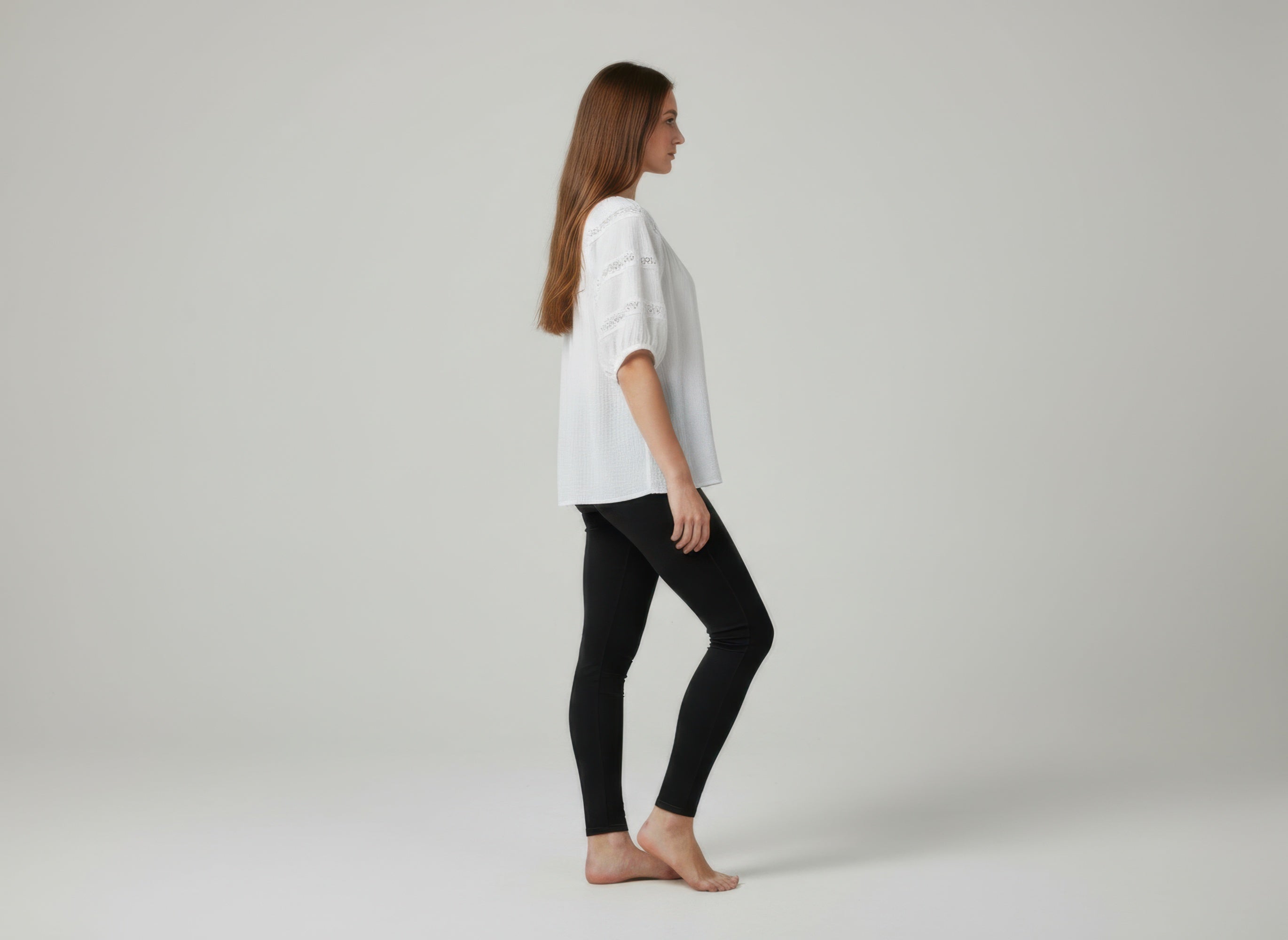 Unique Spectrum solid short sleeve blouse, white side view with lace-like sleeve embroidery