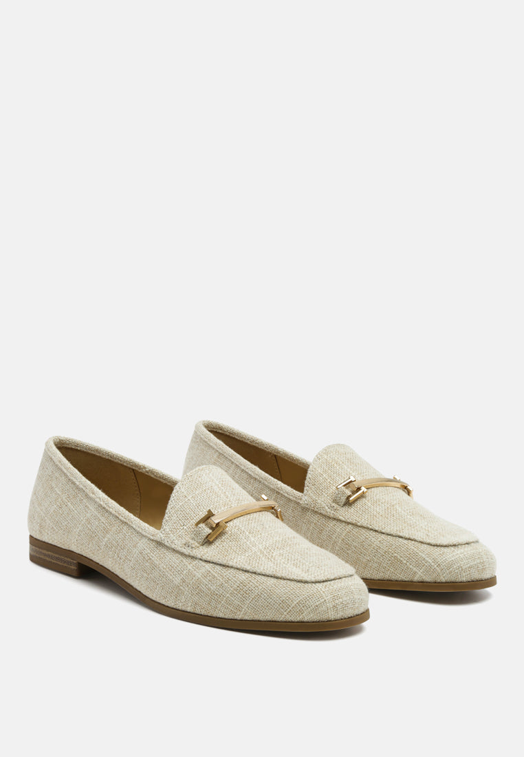 Pair of beige loafers with gold horsebit buckle and closed round toe