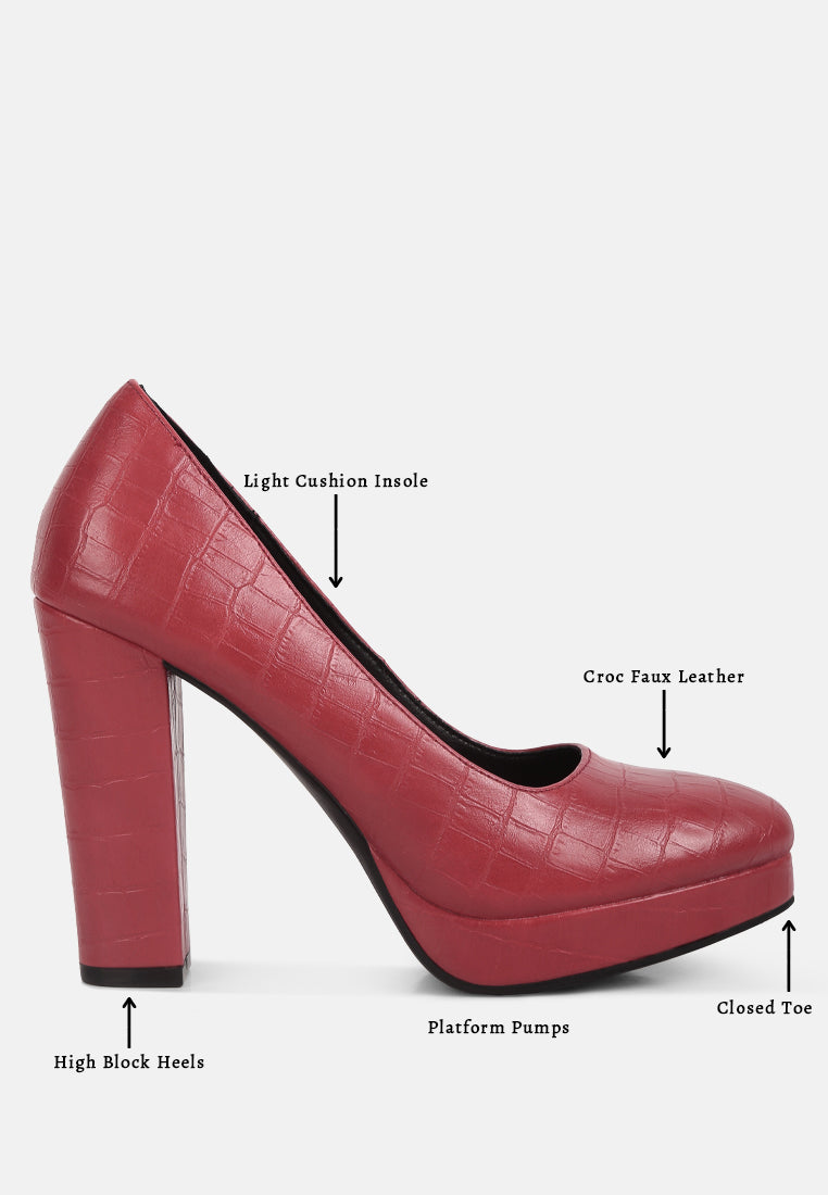 Red croc-texture platform pumps with high block heel and closed toe.