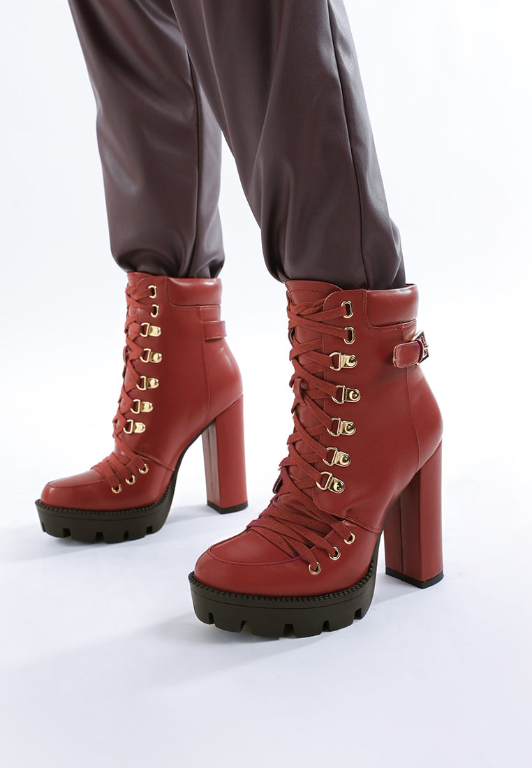 Burgundy lace-up combat boots with high block heel and chunky black tread sole
