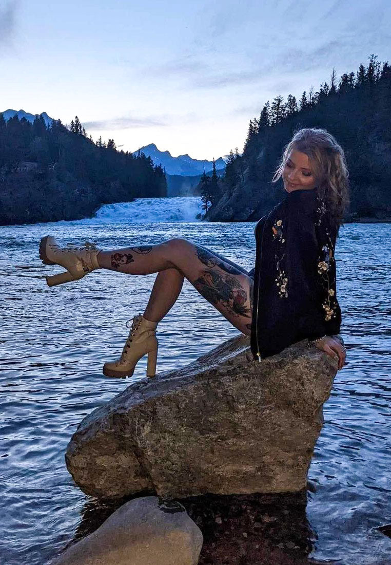 Tan lace-up combat boots with chunky platform sole worn with socks
