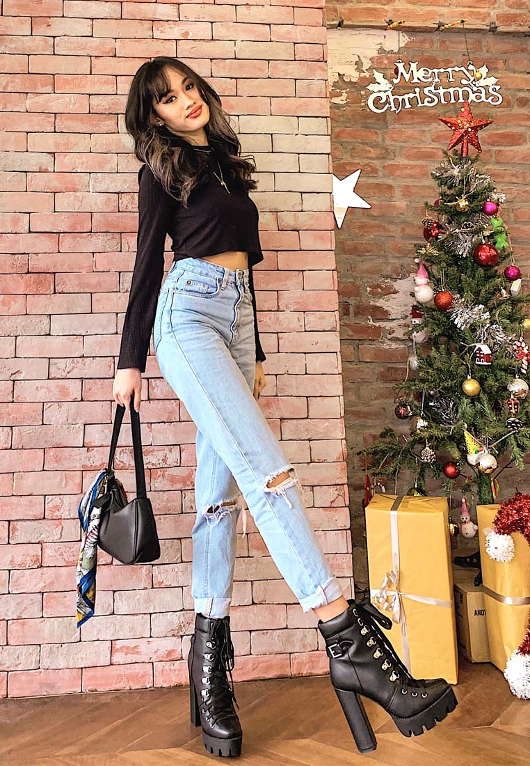 Black combat boots on model: lace-up upper with chunky lug sole and tall heel