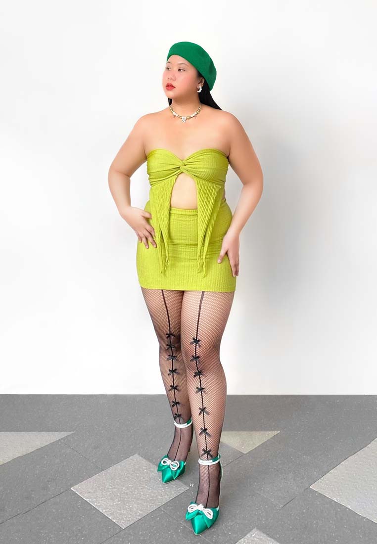High-heel green sandals with rhinestone straps and bow detail on the foot
