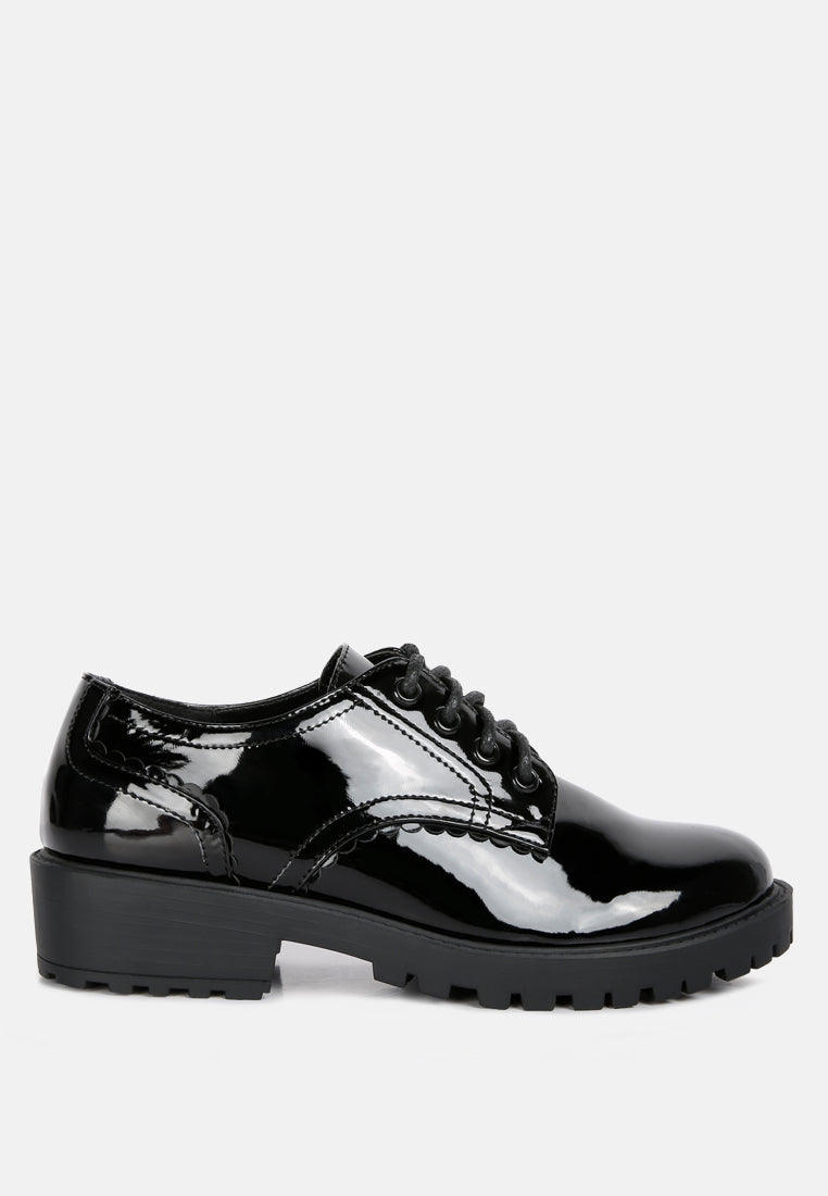 Black patent lace-up derby shoes with chunky rubber sole, front view